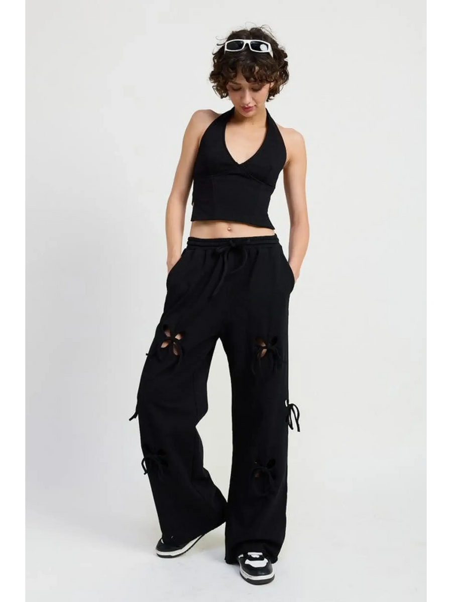Emory Park laser cutout cotton beach pants in black wide leg style worn with black halter top