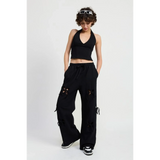 Emory Park laser cutout cotton beach pants in black wide leg style worn with black halter top