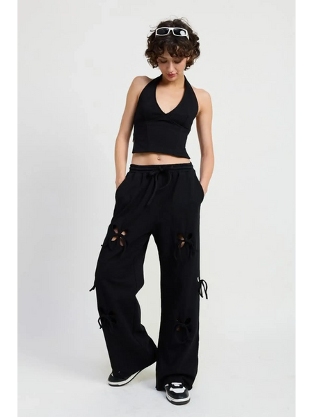 Emory Park laser cutout cotton beach pants in black wide leg style worn with black halter top