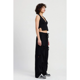 Emory Park laser cutout cotton beach pants in black wide leg style worn by model with black crop top