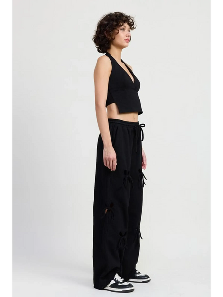 Emory Park laser cutout cotton beach pants in black wide leg style worn by model with black crop top
