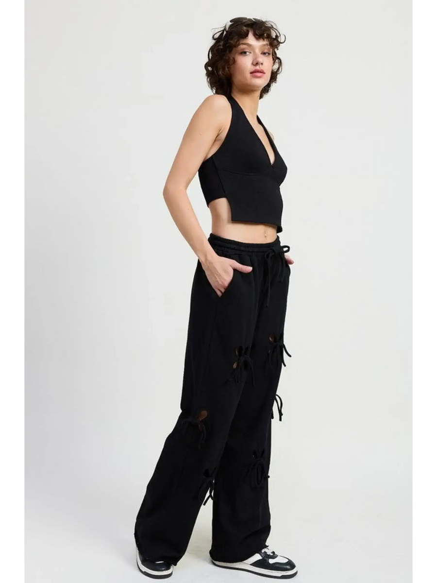Emory Park wide leg laser cutout cotton beach pants in black with drawstring waist worn by model