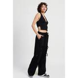 Emory Park wide leg laser cutout cotton beach pants in black with drawstring waist worn by model