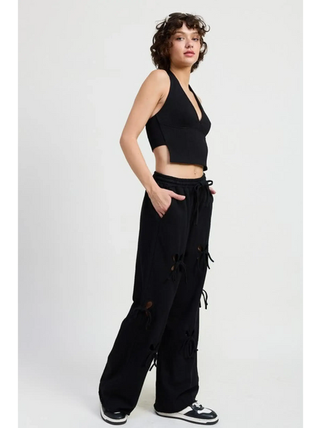 Emory Park wide leg laser cutout cotton beach pants in black with drawstring waist worn by model
