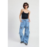 Emory Park wide leg laser cutout cotton beach pants in light blue styled with black tank top and sneakers