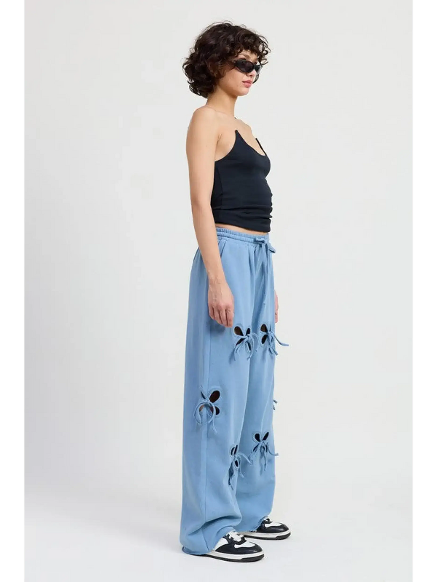 Emory Park laser cutout cotton beach pants in light blue wide leg style worn with black tank and sneakers