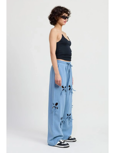 Emory Park laser cutout cotton beach pants in light blue wide leg style worn with black tank and sneakers