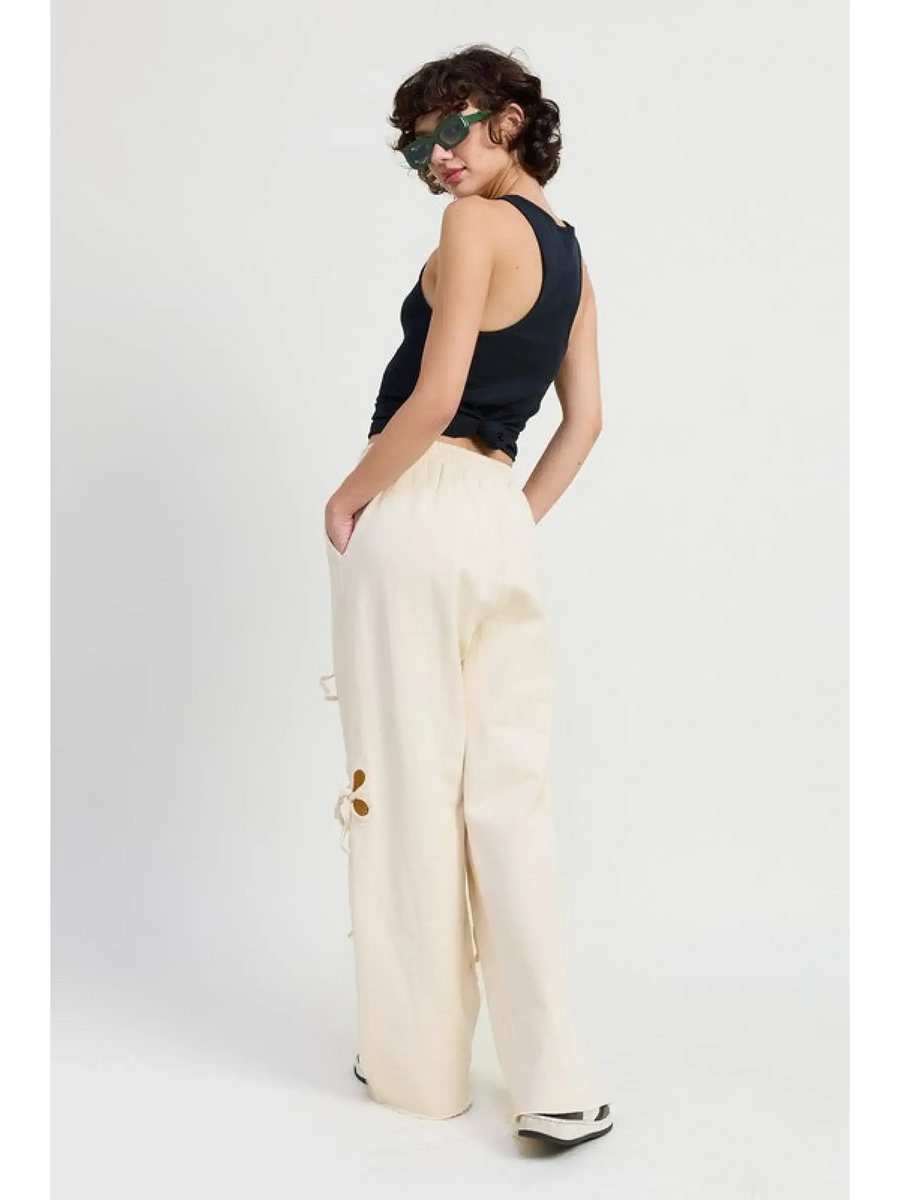 Emory Park wide leg laser cutout cotton beach pants in cream worn by model with black tank top