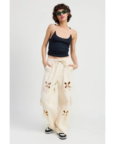 woman wearing Emory Park wide leg laser cutout cotton beach pants in cream with floral cutout details