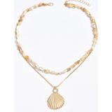Trendsi Layered Shell Necklace with gold pendant and natural shell beads for stylish beachwear