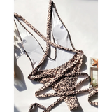 Beach Babes leopard print swimsuit for women with adjustable straps laid flat on white background