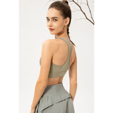 Rear view of woman wearing Babe Beachwear light blue zip front sports bra with racerback design
