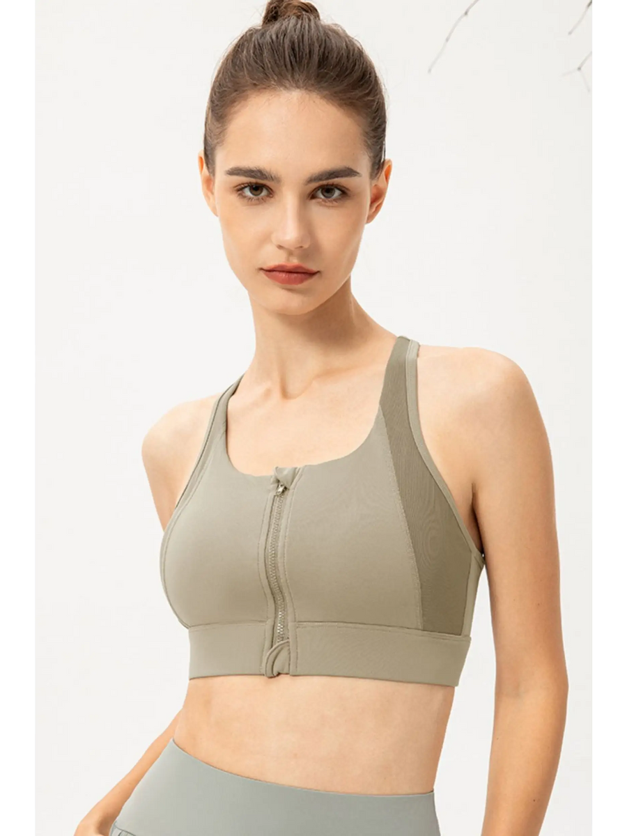 Babe Beachwaer light blue zip front sports bra worn by model with high neck and racerback design