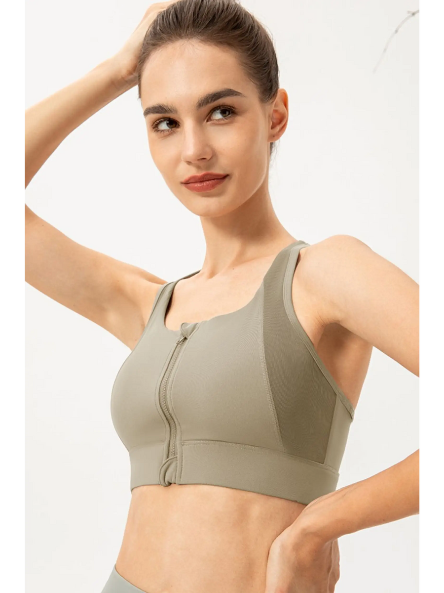 Babe Beachwear light blue zip front sports bra worn by woman in active pose
