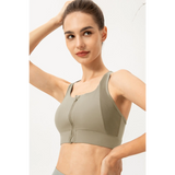 Babe Beachwear light blue zip front sports bra worn by woman in active pose