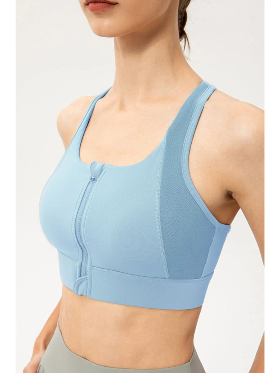 Babe Beachwaer light blue zip front sports bra with racerback design on a model