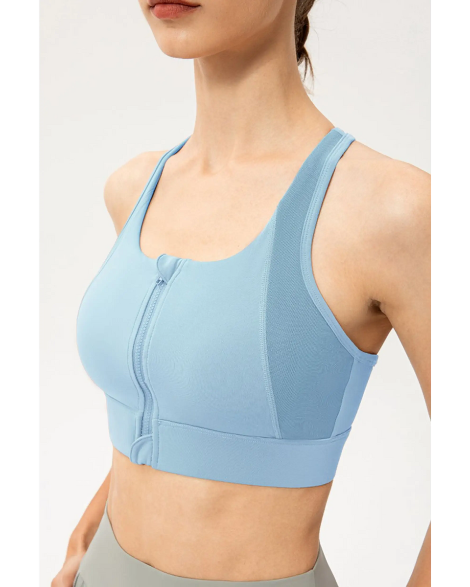 Babe Beachwaer light blue zip front sports bra with racerback design on a model