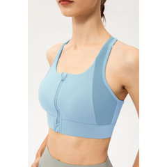 Babe Beachwaer light blue zip front sports bra with racerback design on a model