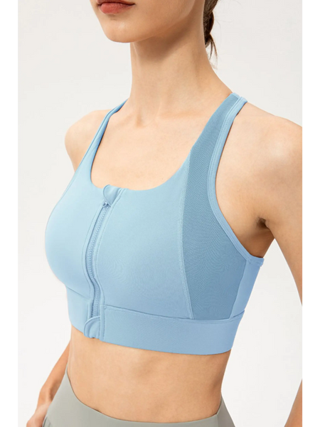 Babe Beachwaer light blue zip front sports bra with racerback design on a model