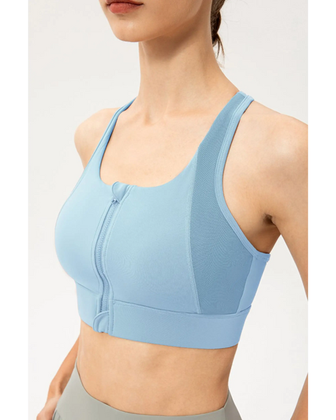 Babe Beachwaer light blue zip front sports bra with racerback design on a model