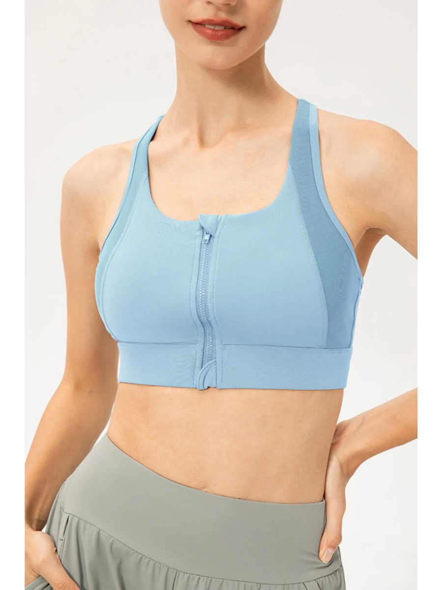 Light blue zip front sports bra by Babe Beachwaer on model showing front zipper and racerback design