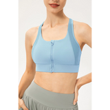 Light blue zip front sports bra by Babe Beachwaer on model showing front zipper and racerback design