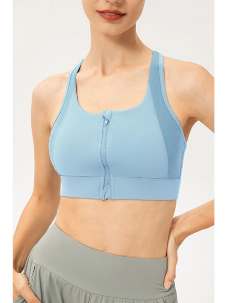 Light blue zip front sports bra by Babe Beachwaer on model showing front zipper and racerback design