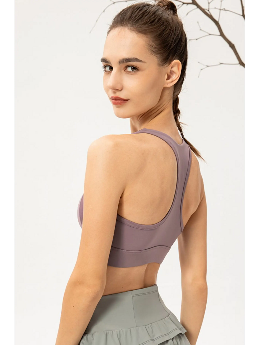 Babe Beachwear light blue zip front sports bra worn by model showing back design and fit