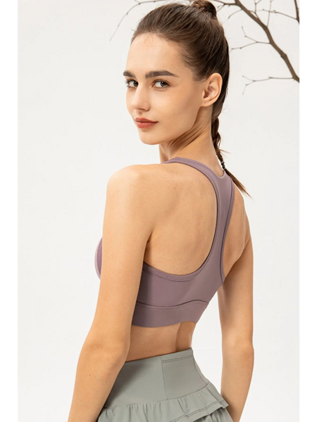 Babe Beachwear light blue zip front sports bra worn by model showing back design and fit