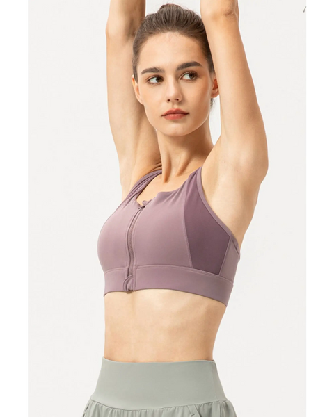Babe Beachwaer light blue zip front sports bra worn by woman raising arms