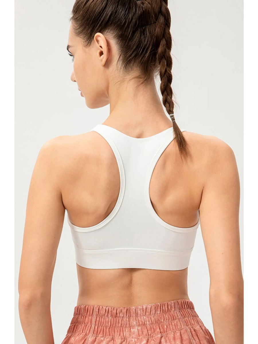 Babe Beachwaer light blue zip front sports bra shown from the back on a model with racerback design