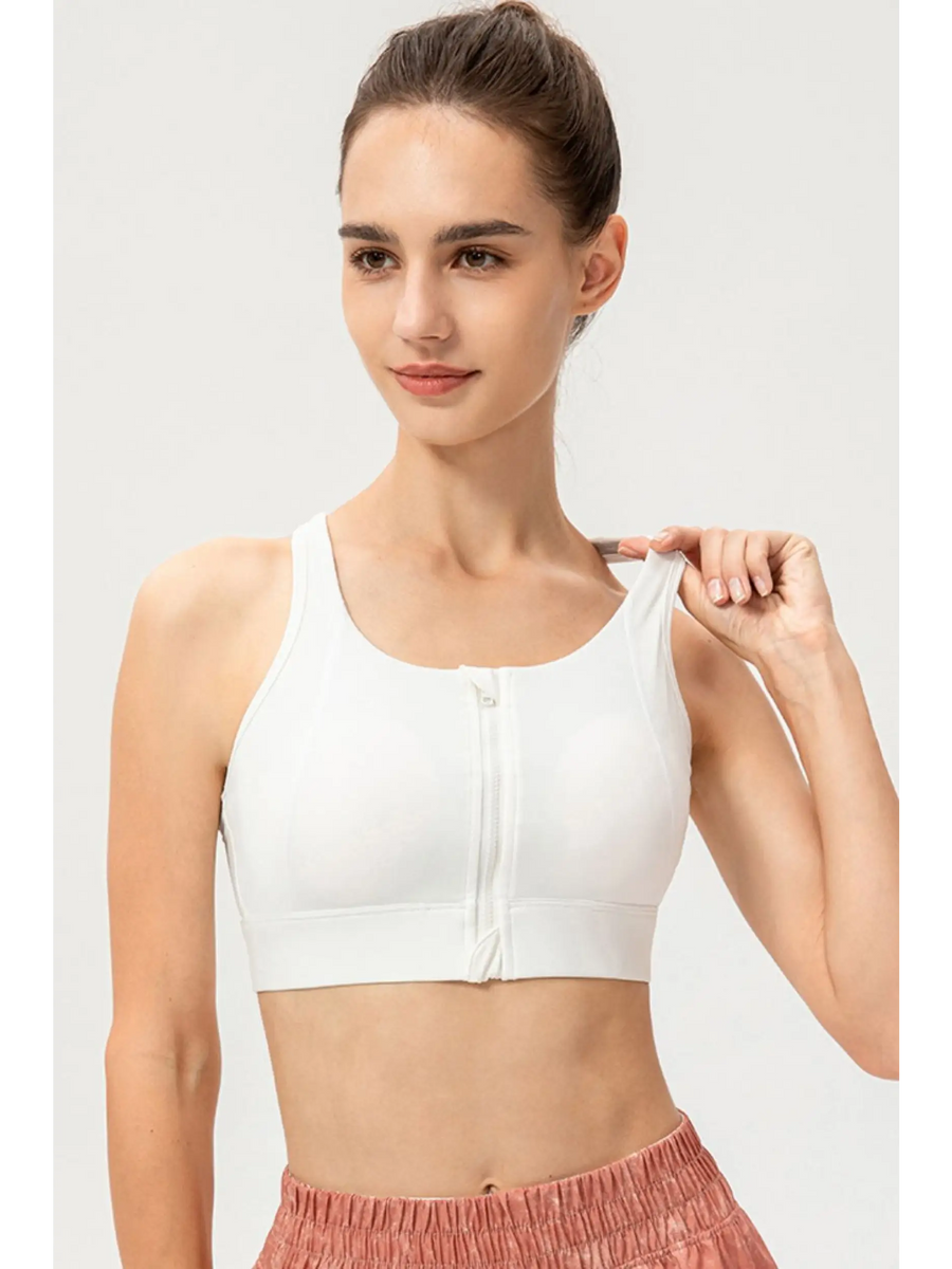 Babe Beachwear light blue zip front sports bra modeled on woman with high ponytail and pink shorts