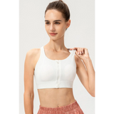 Babe Beachwear light blue zip front sports bra modeled on woman with high ponytail and pink shorts