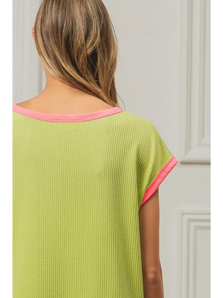 Back view of lime and pink sleeveless shirt by Trendsi with pink trim on sleeves and neckline