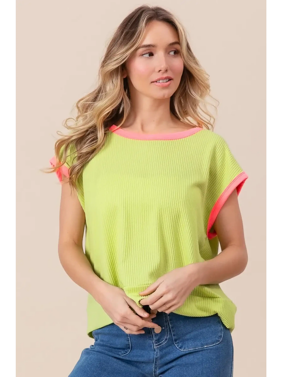 Trendsi lime and pink sleeveless shirt with ribbed texture worn by woman with loose waves