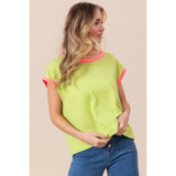 Trendsi lime and pink sleeveless shirt worn by woman with loose waves and blue jeans