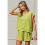 Trendsi lime and pink sleeveless shirt with matching shorts worn by woman with wavy hair