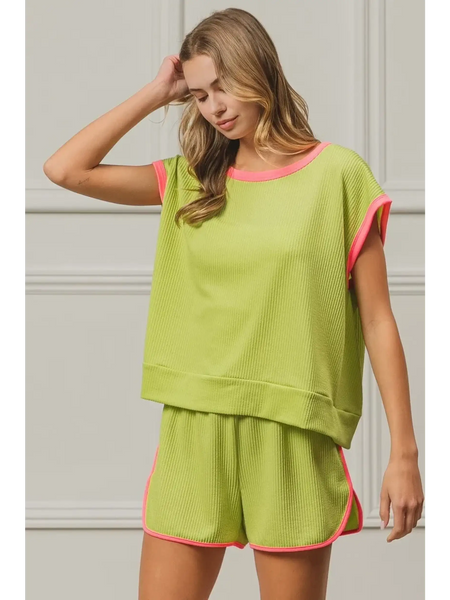 Trendsi lime and pink sleeveless shirt with matching shorts worn by woman with wavy hair
