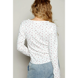  long sleeve beachwear top white with small floral print worn by model from the back
