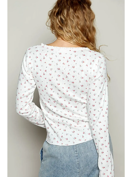  long sleeve beachwear top white with small floral print worn by model from the back