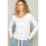 white long sleeve beachwear top with small floral print worn by model