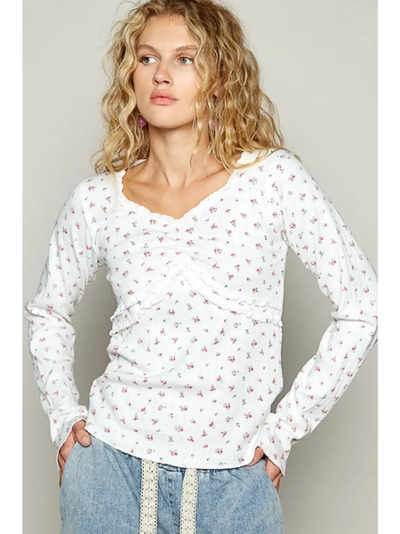 white long sleeve beachwear top with small floral print worn by model