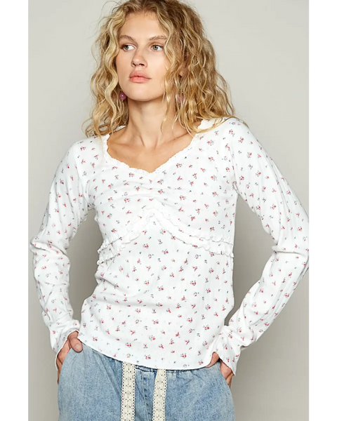 white long sleeve beachwear top with small floral print worn by model