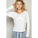 white long sleeve beachwear top with small floral print on female model