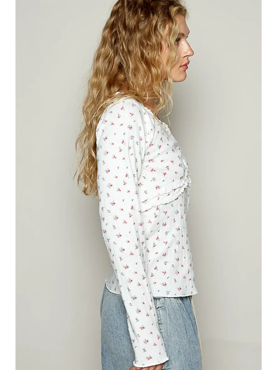 long sleeve beachwear top with small floral print worn with light denim jeans
