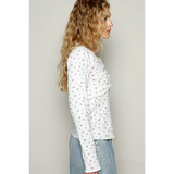 long sleeve beachwear top with small floral print worn with light denim jeans