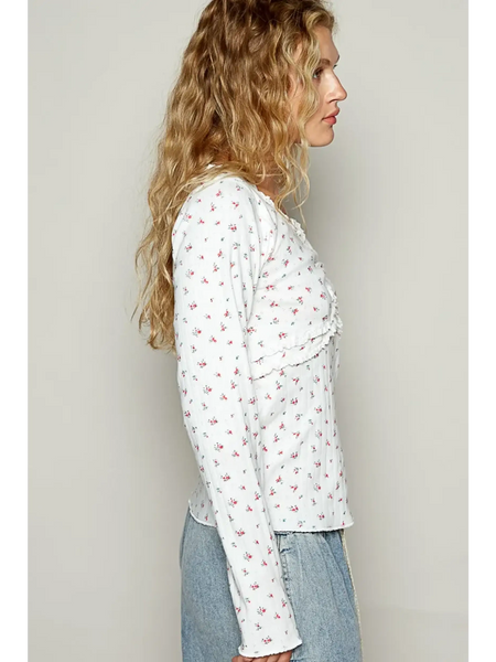 long sleeve beachwear top with small floral print worn with light denim jeans