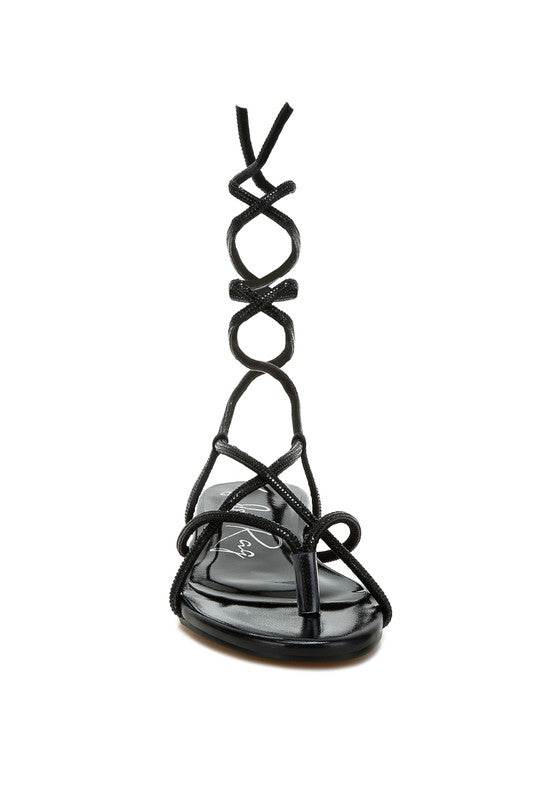 Rag Company black lace-up sandals featuring intricate straps and a flat sole design
