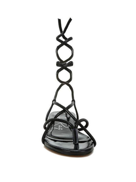Rag Company black lace-up sandals featuring intricate straps and a flat sole design