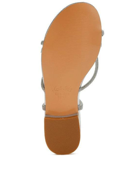 Bottom view of Rag Company gold strappy sandals with a smooth tan sole and low heel